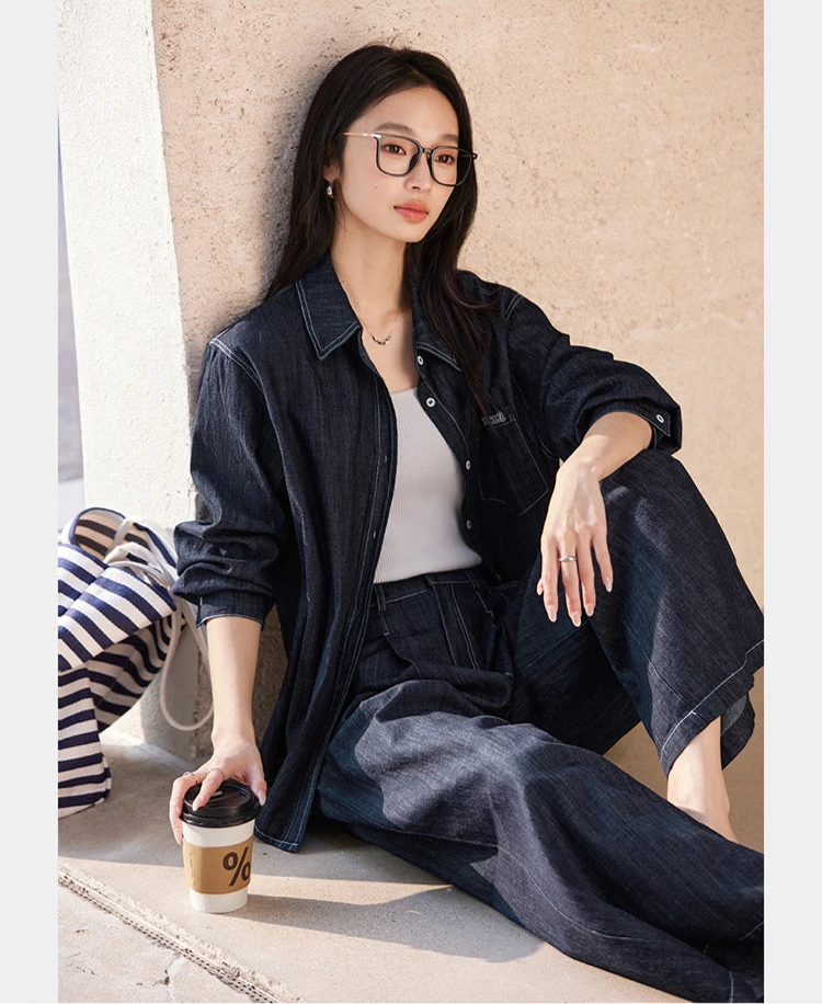 Model seated on city steps wearing the Midnight Express set — relaxed silhouette with contrast topstitching and lived-in confidence. From Borcelleclothes.