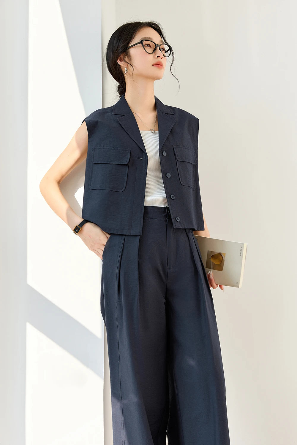 Model in Mirage set about to place hand in trousers pocket, capturing motion within a composed, structured look. From Borcelleclothes.
