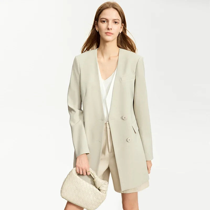 Women’s Moon Mist wrap blazer, model with bent leg holding bag – From Borcelleclothes.