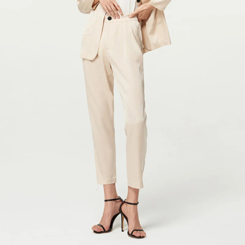 Women’s Mulberry silk satin pants in Pearl Bush — slim-cut, ankle-length trousers with front pleats and a soft waistband, designed for movement without demand. From Borcelleclothes.