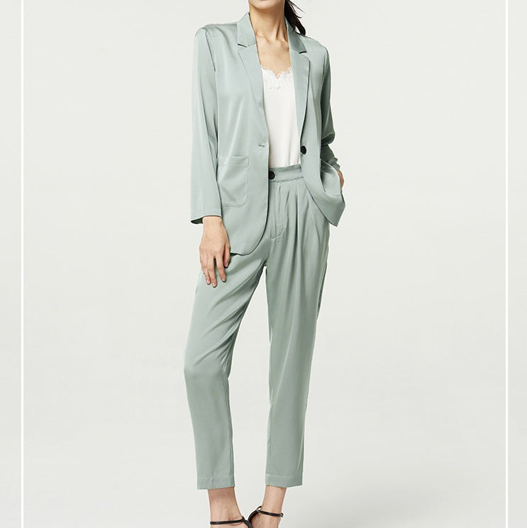 Woman in Nebula satin set with bent leg — the silk moves with the body, offering softness and control in equal measure. From Borcelleclothes.