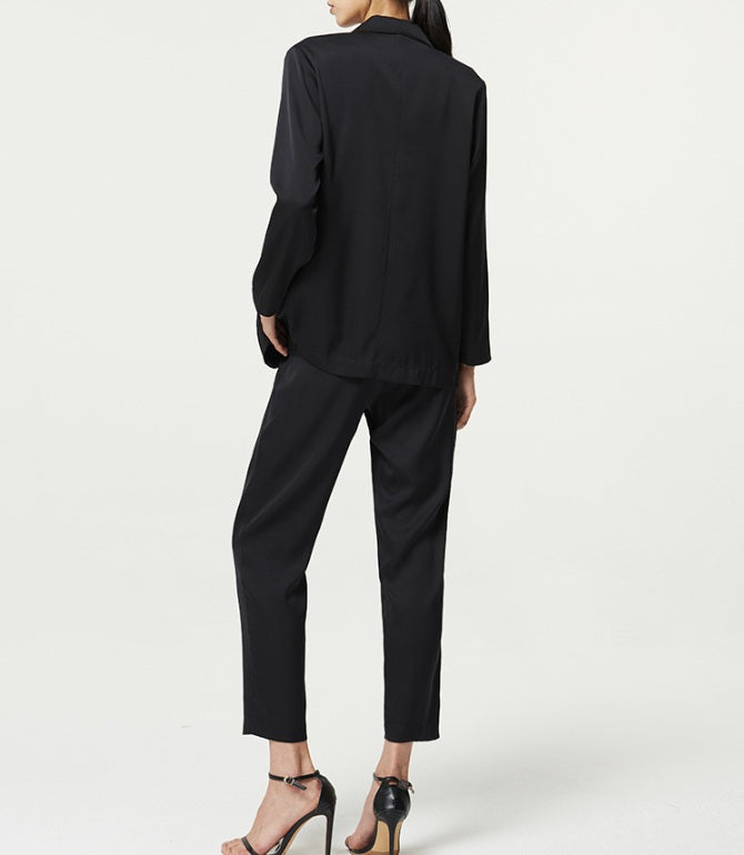 Back view of the Onyx silk satin set — fluid lines and natural drape following the silhouette without clinging. From Borcelleclothes.