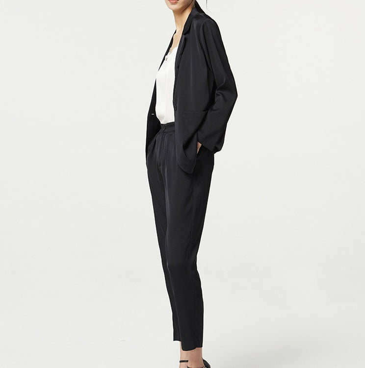 Woman in the Onyx Mulberry silk satin set, turned to the side — the double-faced satin reflecting light with quiet depth. From Borcelleclothes.