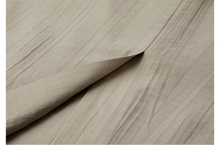 Back vent of the jacket in the Olive Haze two-piece set, combining movement and structure. From Borcelleclothes.