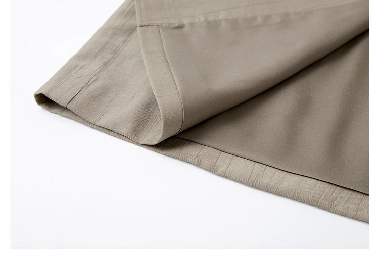 Unfolded bottom hem of the jacket in Olive Haze color, revealing lining texture and tailoring. From Borcelleclothes.