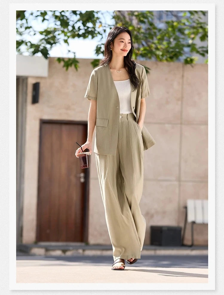 Close-up of the model’s hand in the trousers pocket of the Olive Haze two-piece set, highlighting relaxed tailoring. From Borcelleclothes.