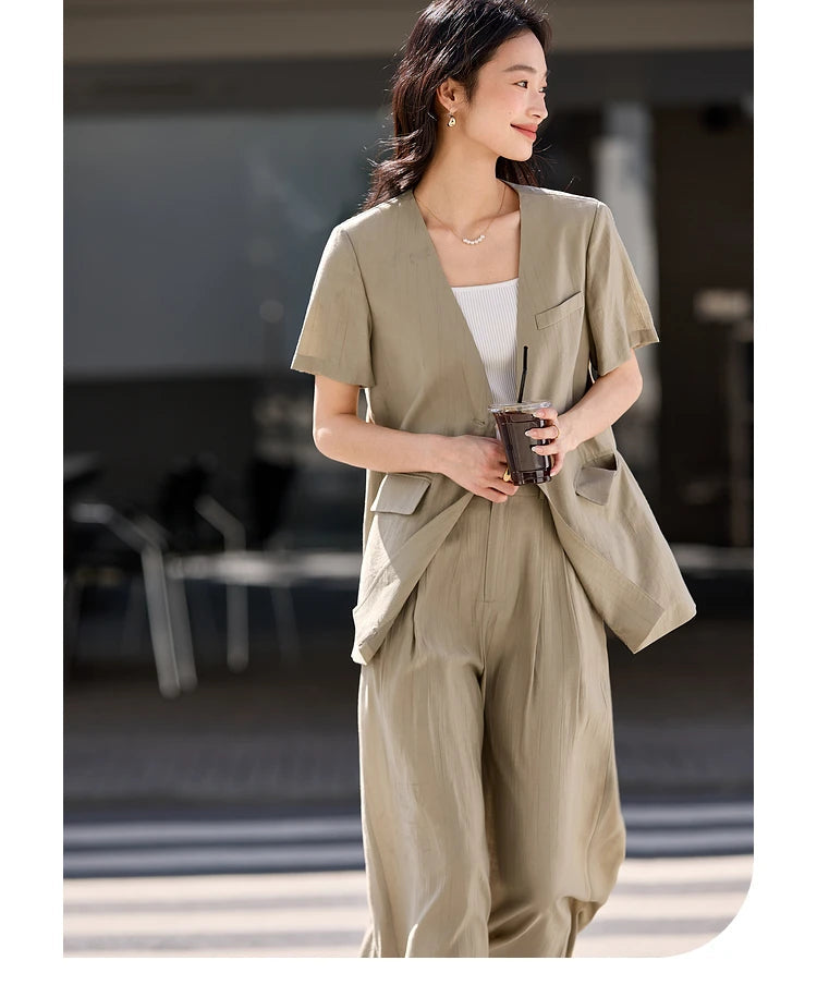 Model holding a coffee cup while wearing the Olive Haze two-piece set, conveying relaxed elegance. From Borcelleclothes.