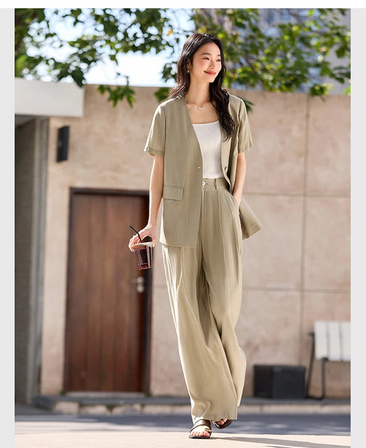Women's two-piece set in Olive Haze with crinkled texture, featuring a short-sleeved V-neck jacket and wide-leg trousers in a relaxed silhouette. From Borcelleclothes.