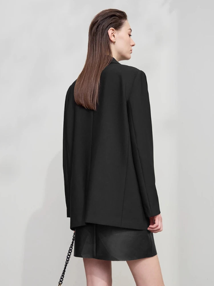 Model wearing Onyx minimal blazer, back view with long straight lines and vent – From Borcelleclothes.