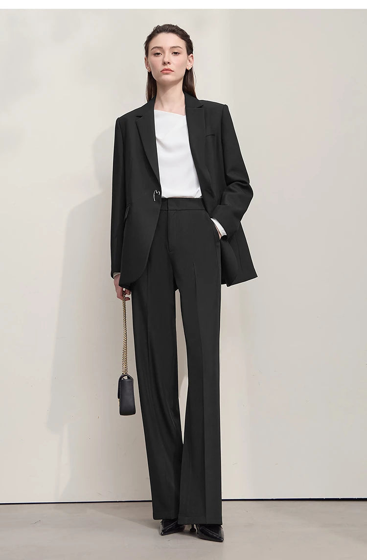 Model in Onyx minimal blazer with hand in pants pocket, minimalist black look – From Borcelleclothes.