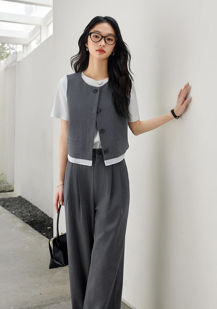 Model in the Payne’s Grey two-piece set, resting one hand against the wall in a poised, quiet stance. From Borcelleclothes.