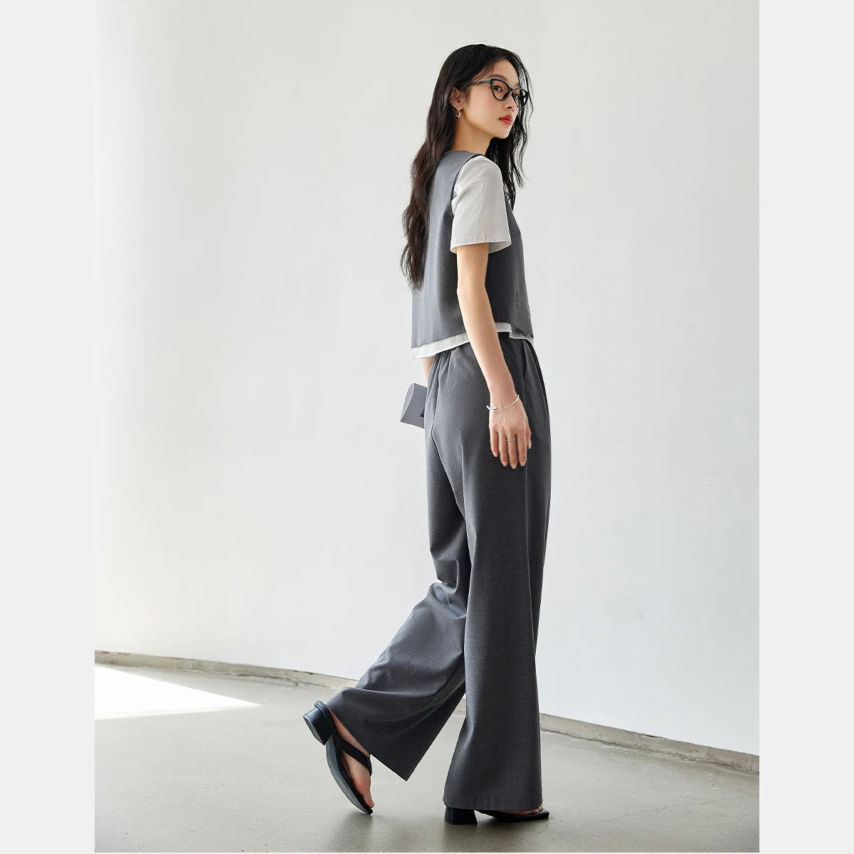 Side view of the model in the Payne’s Grey two-piece set, showing the soft structure and composed silhouette. From Borcelleclothes.