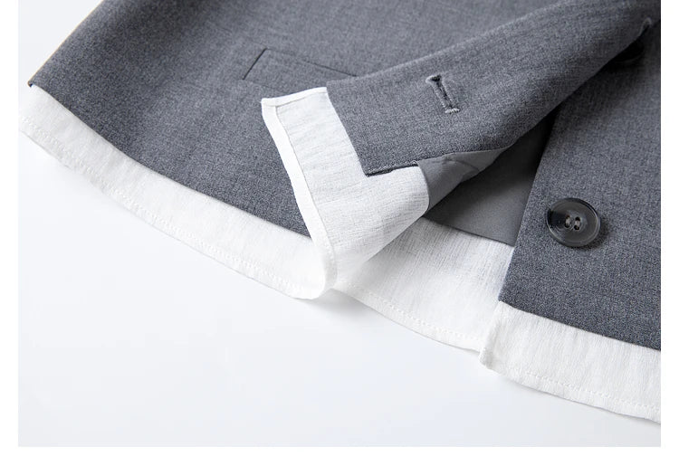 Close-up of the vest’s bottom hem with shirt-inspired insert in the Payne’s Grey two-piece set. From Borcelleclothes.