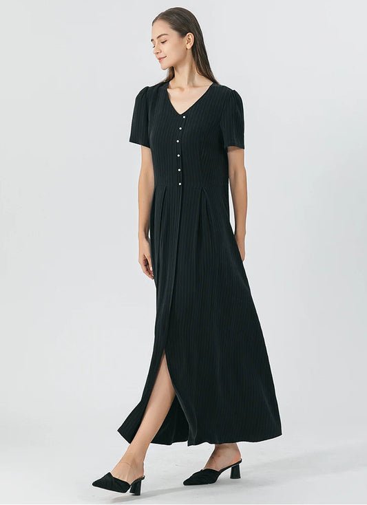 Model reveals the flared bottom construction of the pinstripe silk wrap dress in Jaguar color, showcasing the skirt’s overlap and drape. From Borcelleclothes.