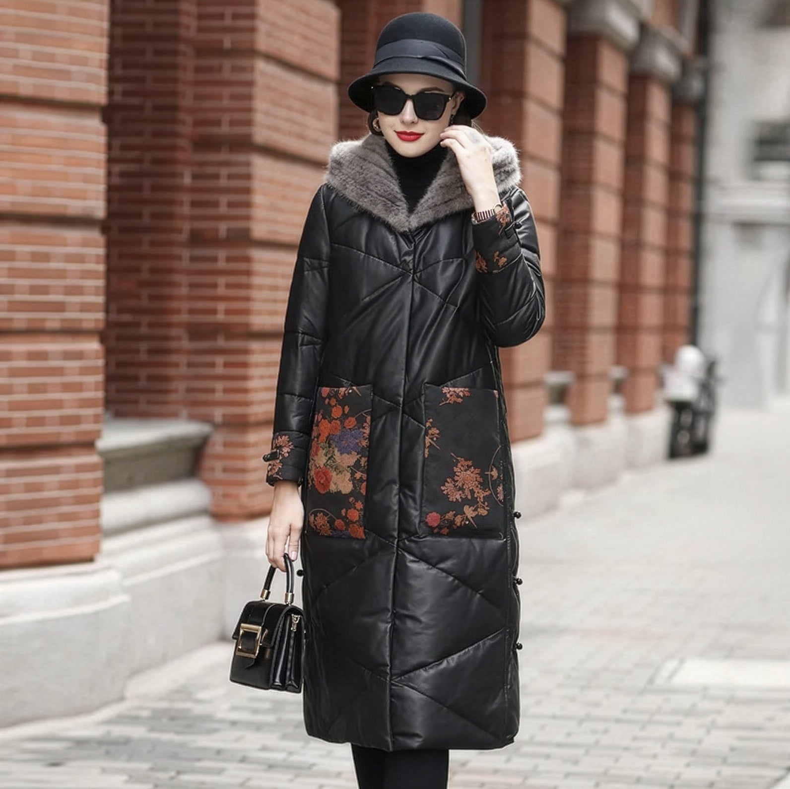 Model touching her face while wearing the Onyx sheepskin coat with mink-lined hood, floral-printed leather cuffs, and zigzag quilting — From Borcelleclothes.