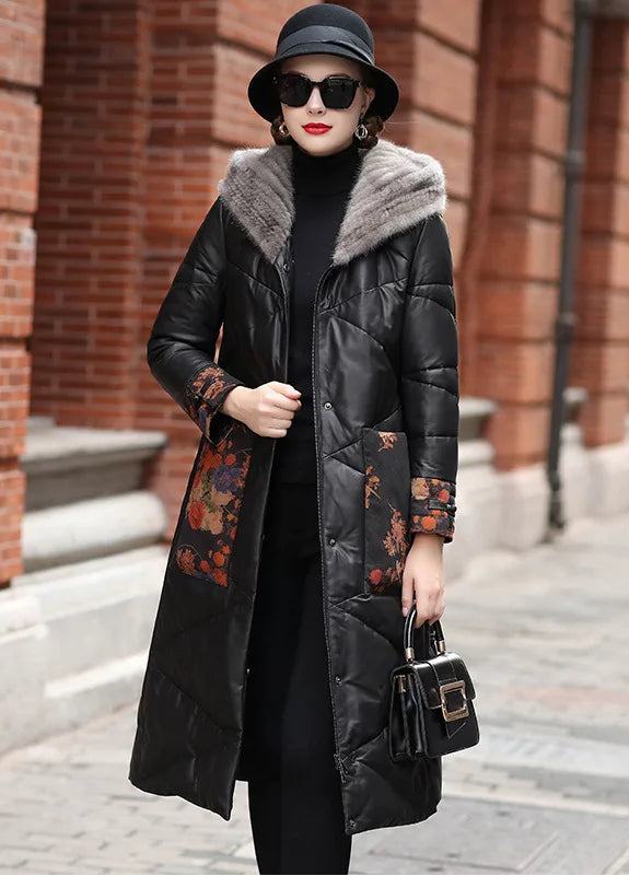 Women's sheepskin coat in Onyx with mink-lined hood, printed floral leather cuffs and pockets, tonal zigzag quilting, and decorative knot closures — From Borcelleclothes.