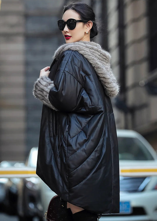Model in Onyx rounded hem down coat with batwing sleeves and sculpted mink hood, shown in side view — From Borcelleclothes.