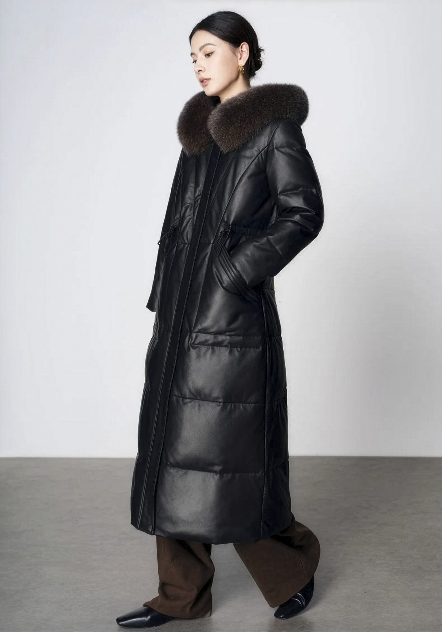 Women's Sheepskin Coat with Hidden Casing in Onyx — model walking, side view. From Borcelleclothes.