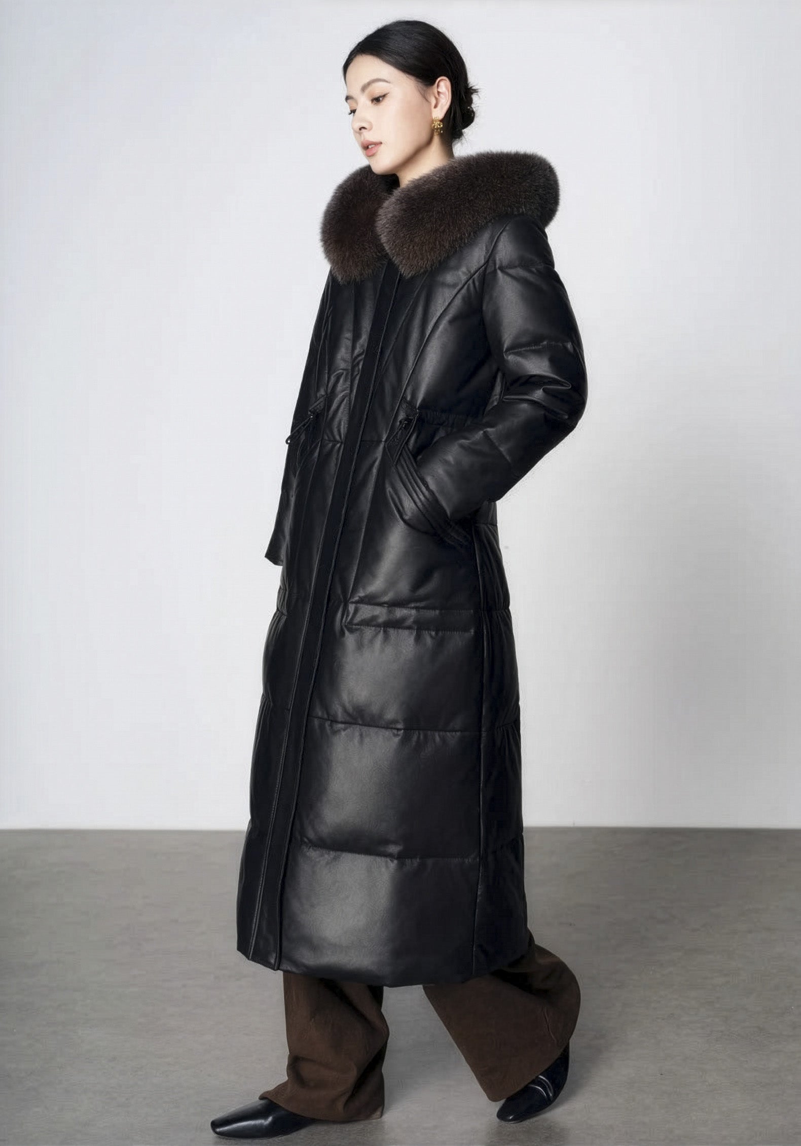 Women's Sheepskin Coat with Hidden Casing in Onyx — model walking, side view. From Borcelleclothes.