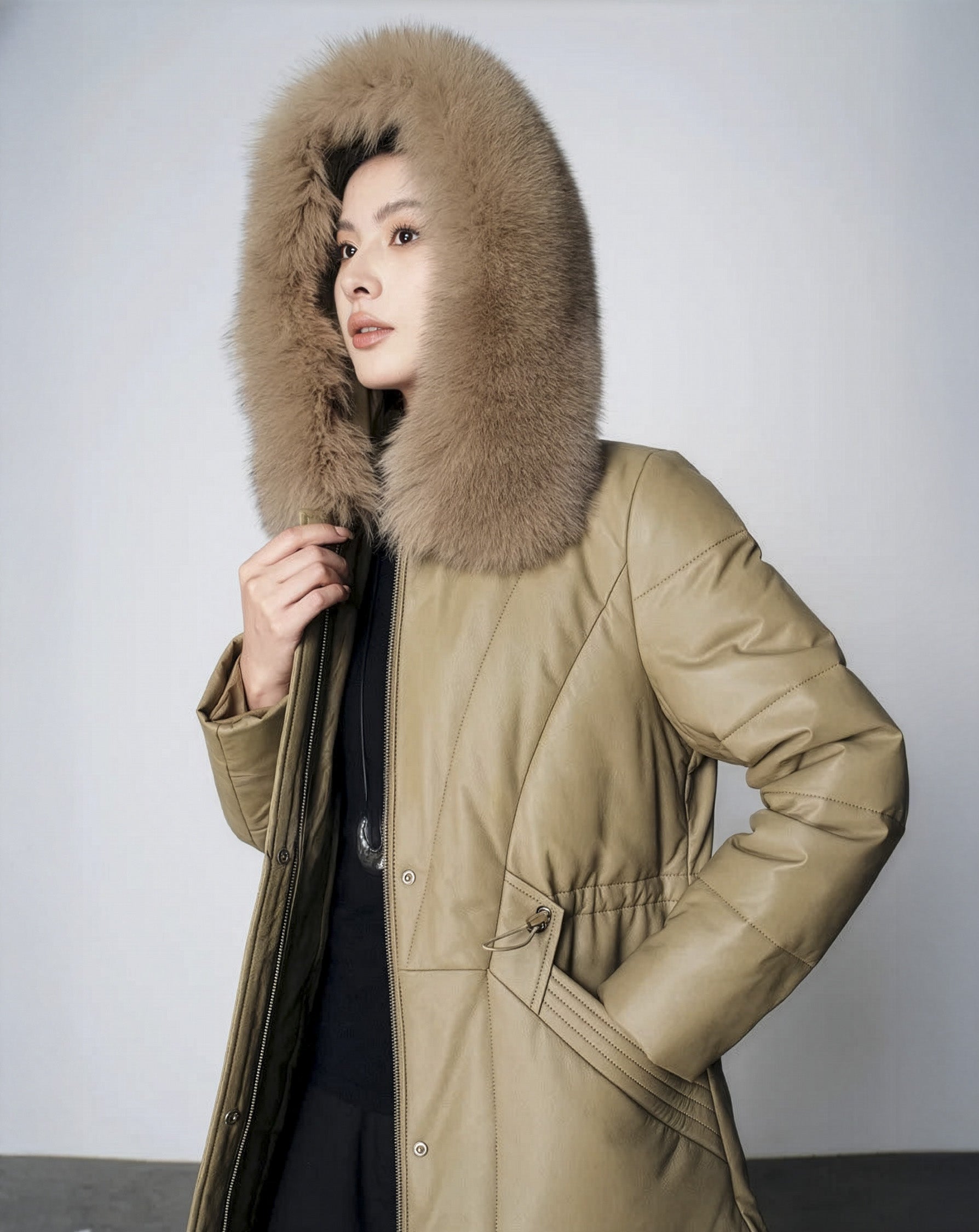 Women's Sheepskin Coat with Hidden Casing in Sweet Angelica — model with lifted hood. From Borcelleclothes.