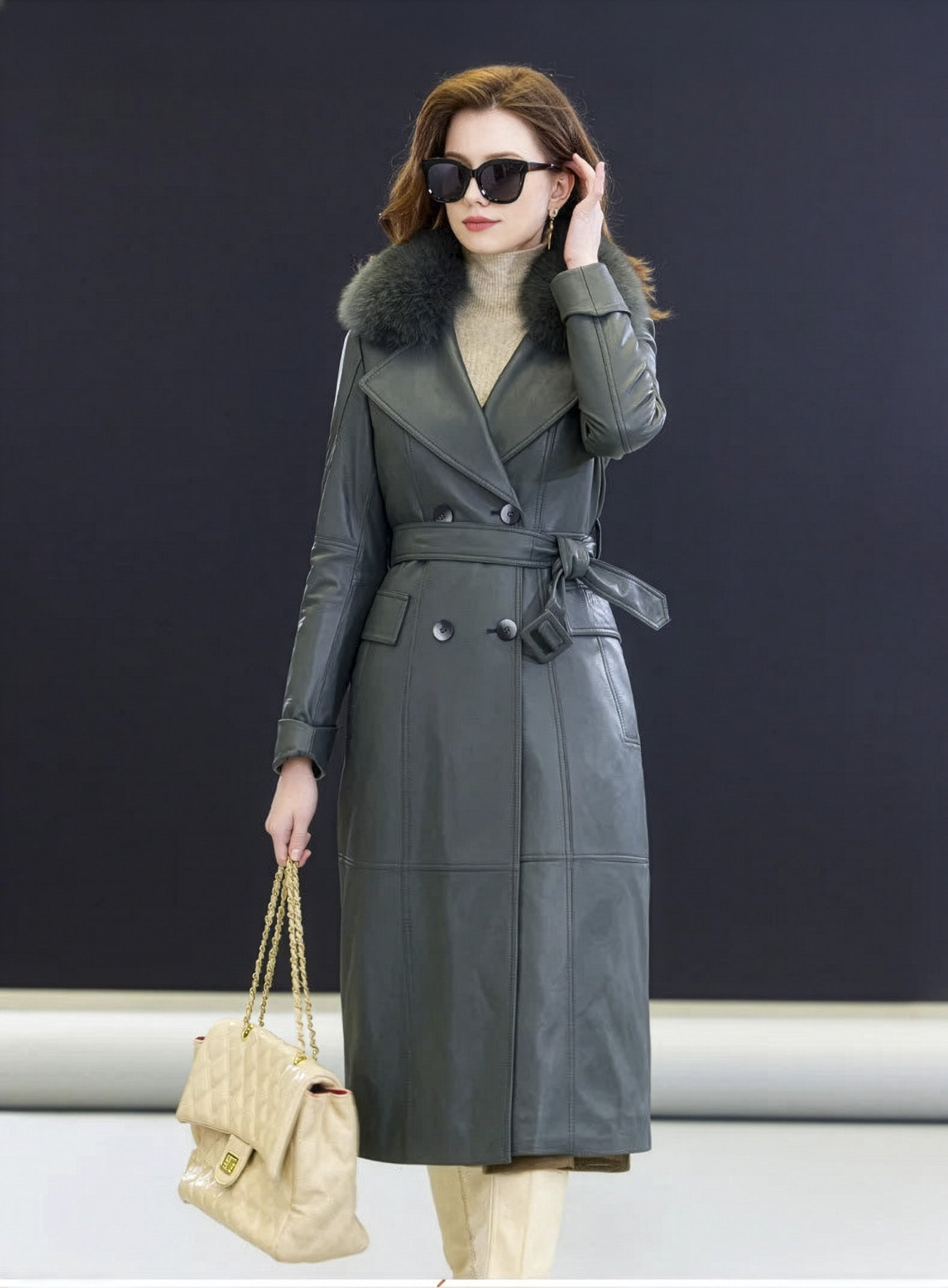 Model adjusting hair in the Independence coat, wide lapels opening into quiet confidence — From Borcelleclothes.