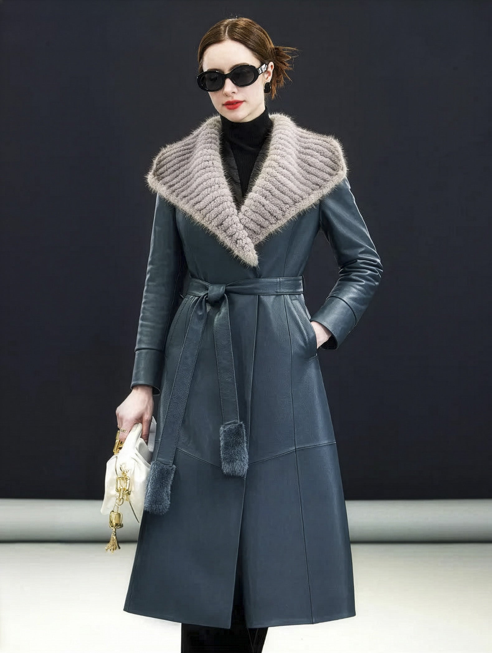 Model in Independence coat resting hand in diagonal welt pocket, waist cinched — From Borcelleclothes.