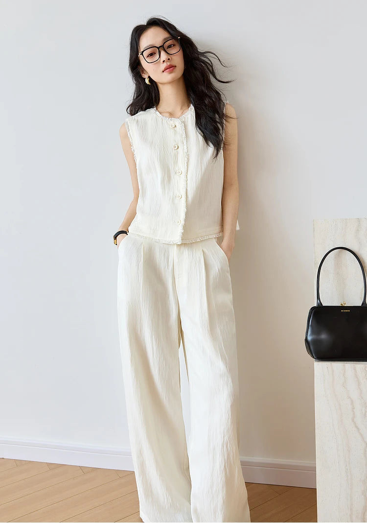 Women’s two-piece set in Spring Wood with sleeveless fringe-trimmed tops and pleated wide-leg trousers in breathable textured fabrics. From Borcelleclothes.