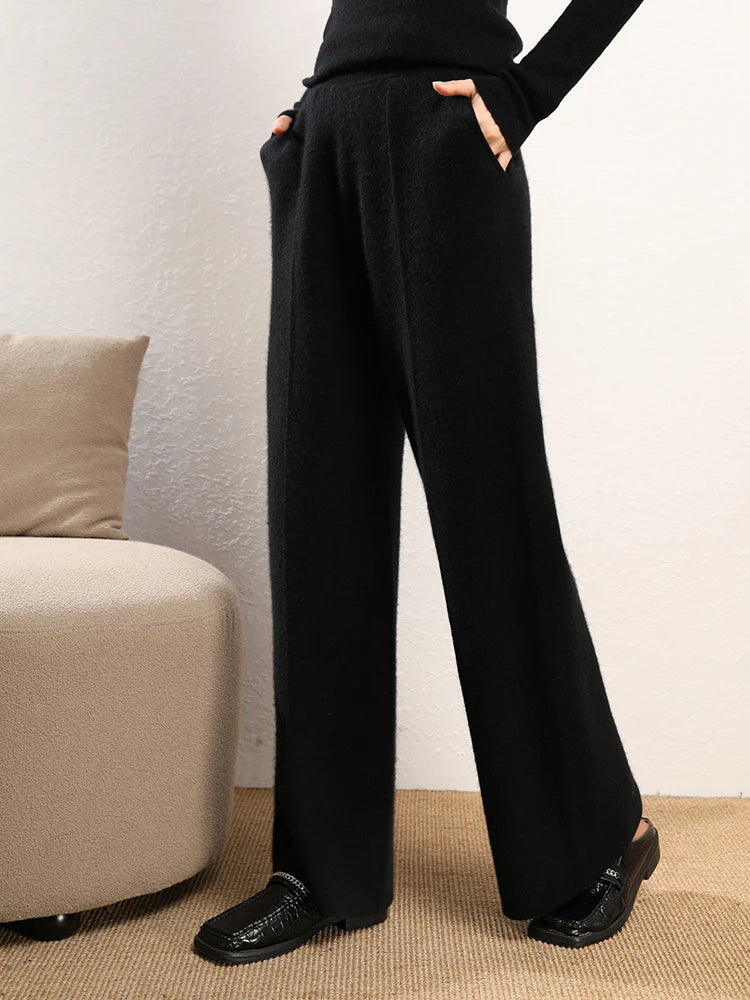 Model with hands in pockets wearing Onyx straight-cut Alashan cashmere trousers — From Borcelleclothes.