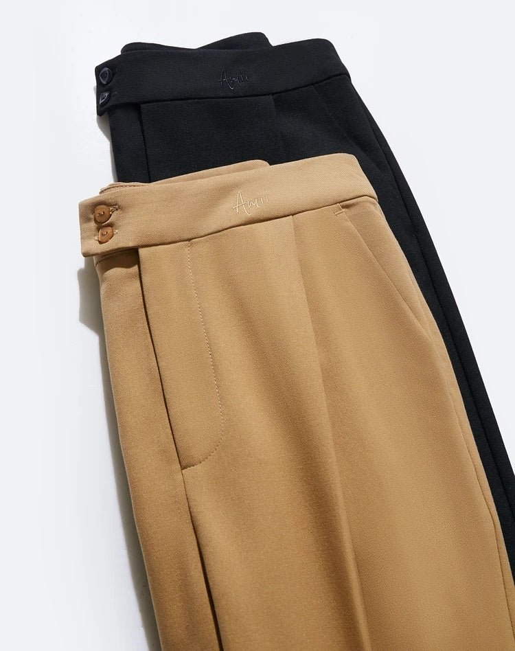 Folded view of tailored cropped trousers in Sand Brown and Onyx, showing texture and tonal contrast. From Borcelleclothes.