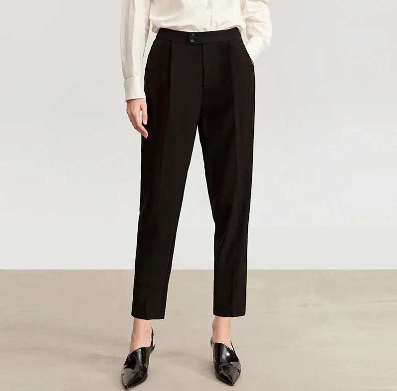 Model placing hand in the pocket of Onyx tailored cropped trousers, highlighting functional side pocket. From Borcelleclothes.