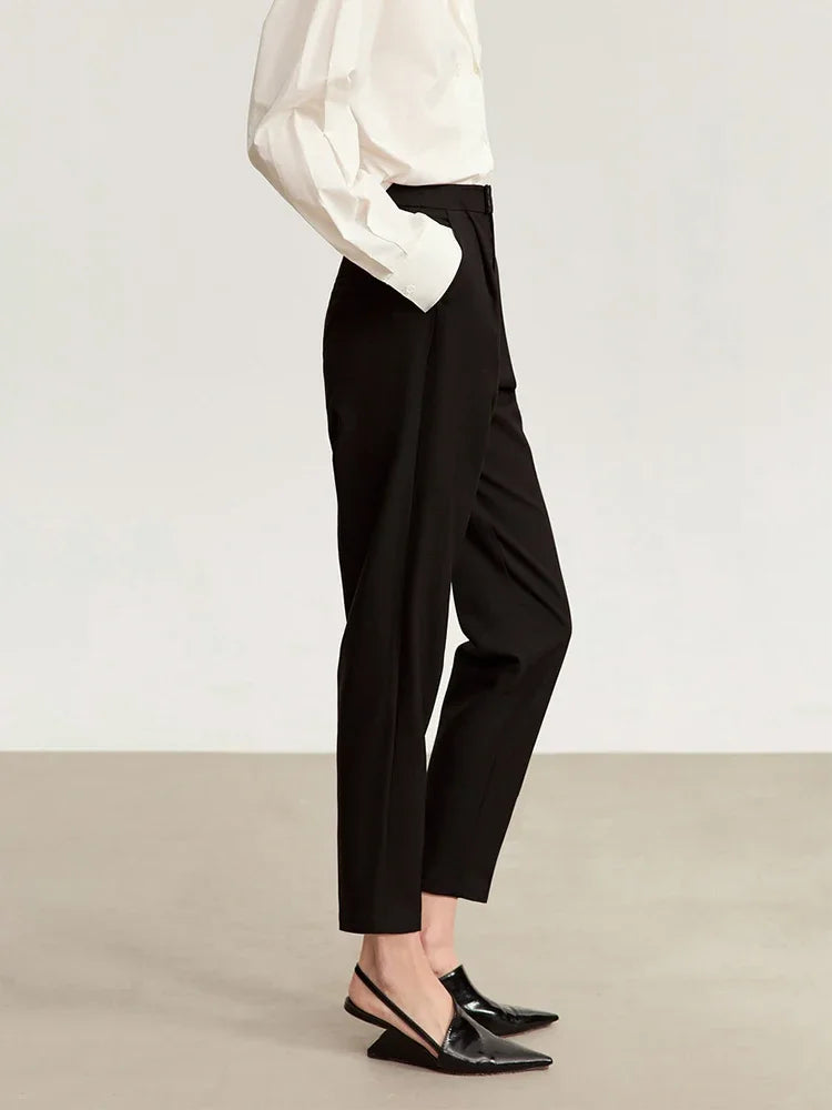 Right side view of Onyx trousers, showing the silhouette’s clean structure and directional pleating. From Borcelleclothes.