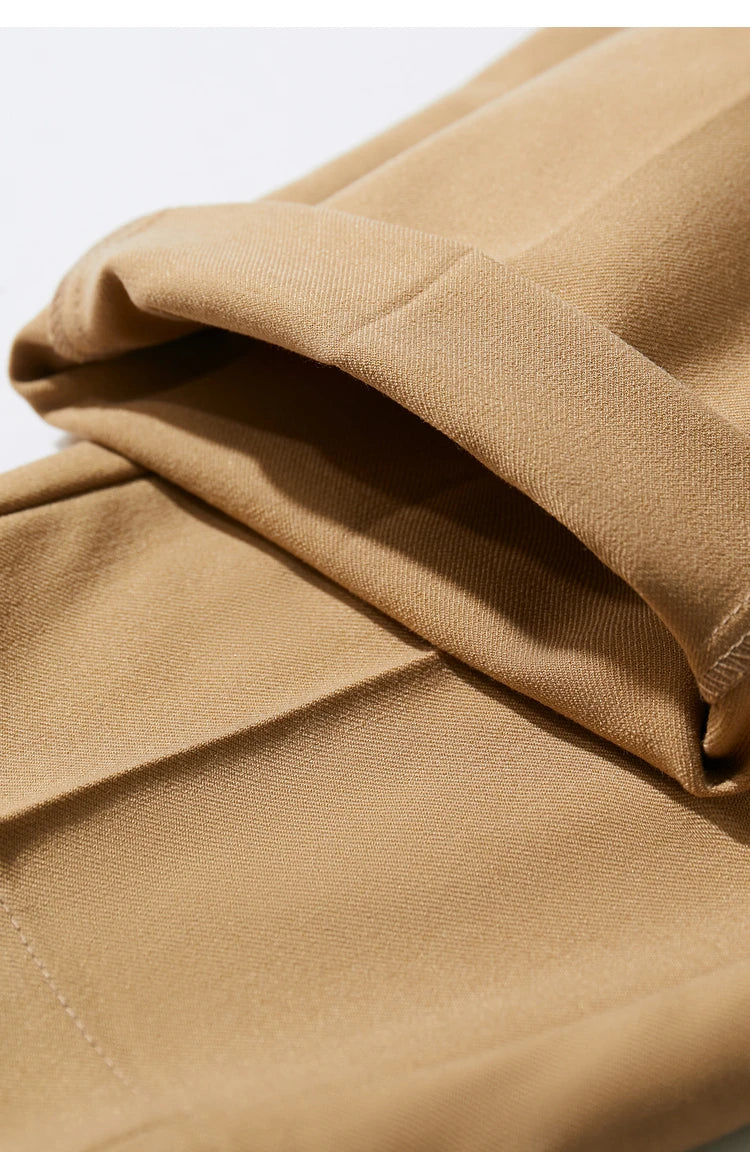 Close-up of the folded hem on Sand Brown tailored cropped trousers, revealing the ankle-grazing length. From Borcelleclothes.