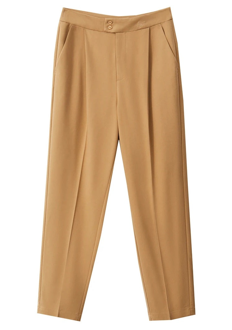 Front draping of Sand Brown cropped trousers, capturing the fluid structure of the pleated silhouette. From Borcelleclothes.