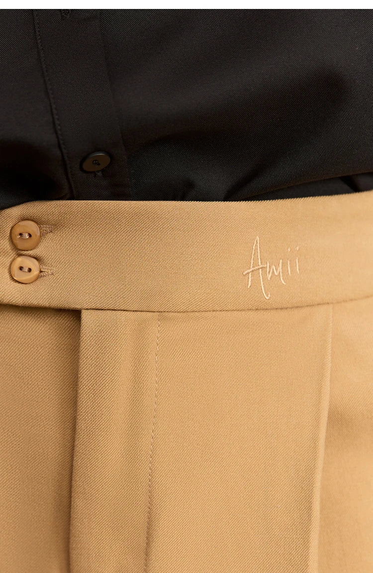 Detail of the Sand Brown trousers’ tonal decorative buttons and subtle AMII embroidery at the waistband. From Borcelleclothes.
