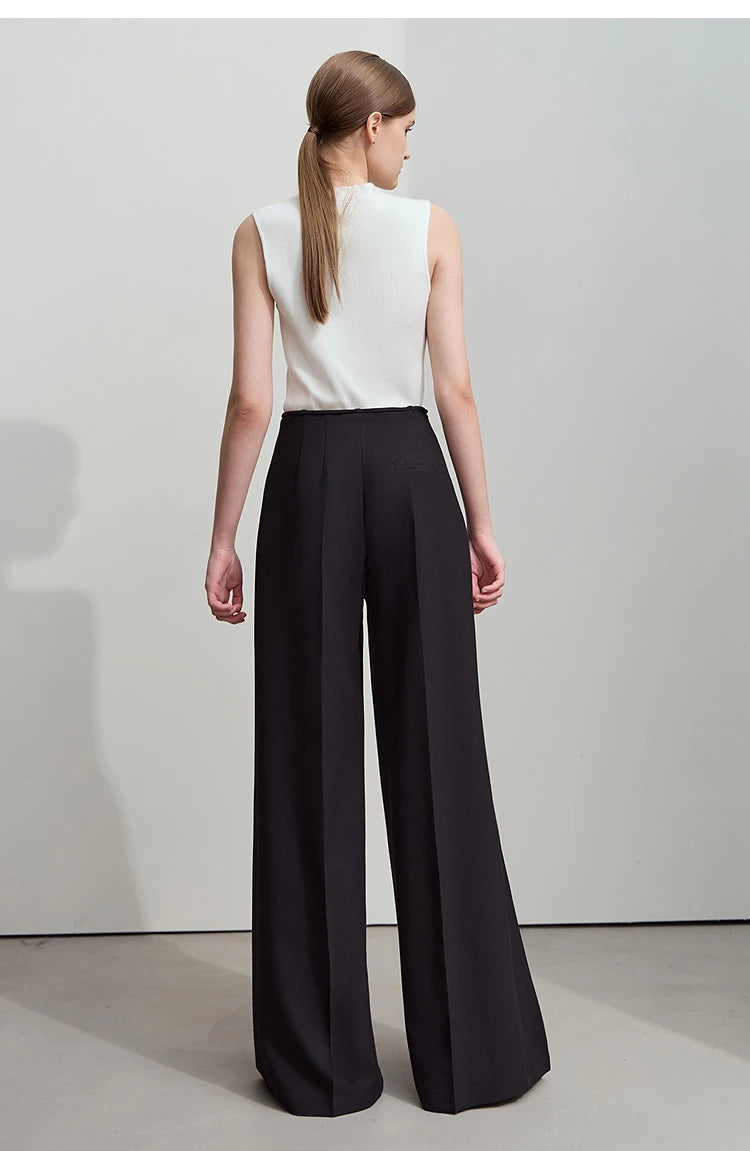Back view of Onyx trousers with softly falling pleats and structured elegance. From Borcelleclothes.