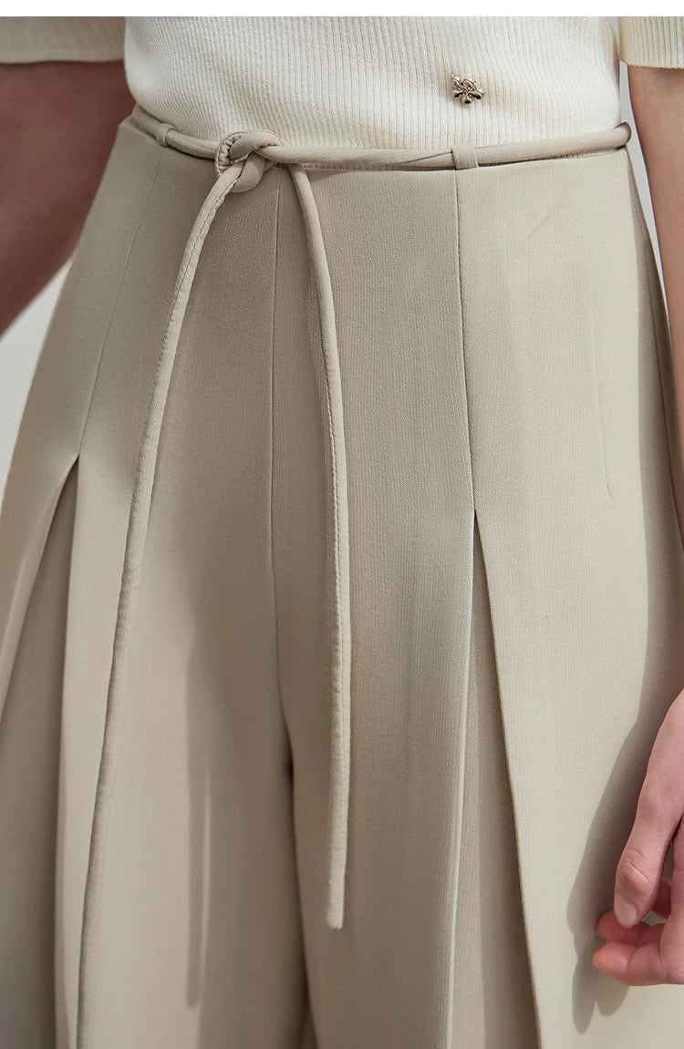 Upper view of the trousers showing the waistband area with soft belt loops and flowing pleats. From Borcelleclothes.