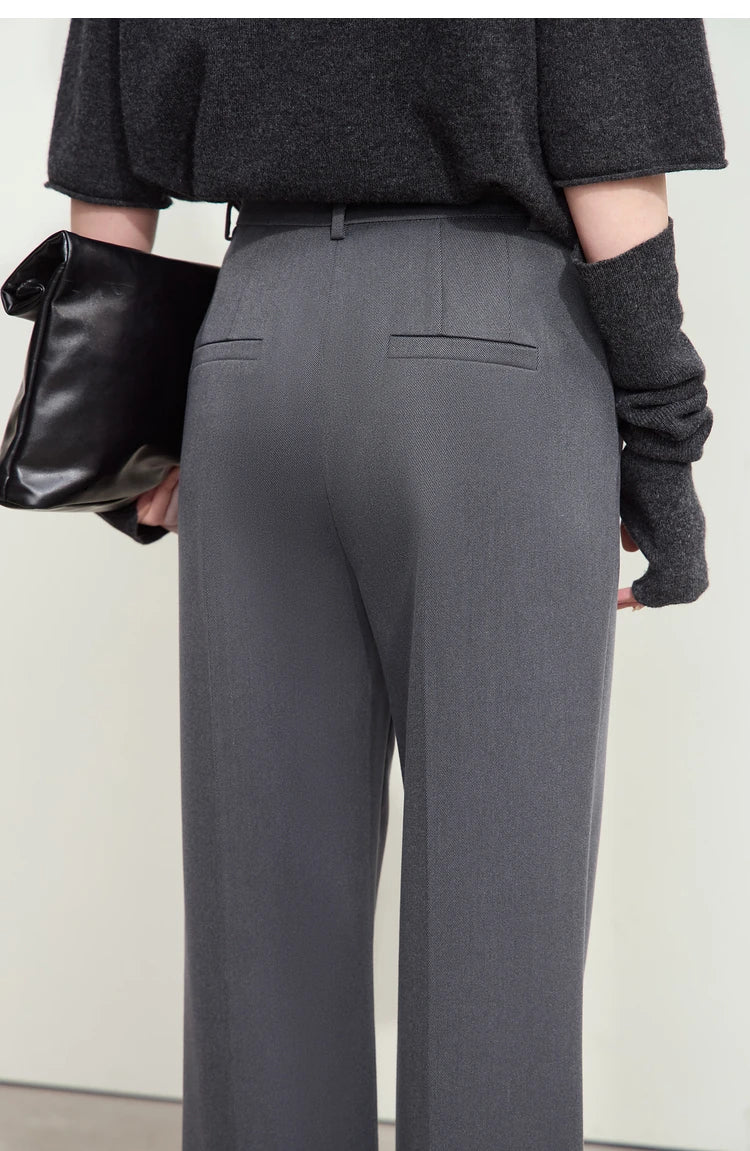 Model in Dolphin trousers, upper back view — refined structure with streamlined details. From Borcelleclothes.