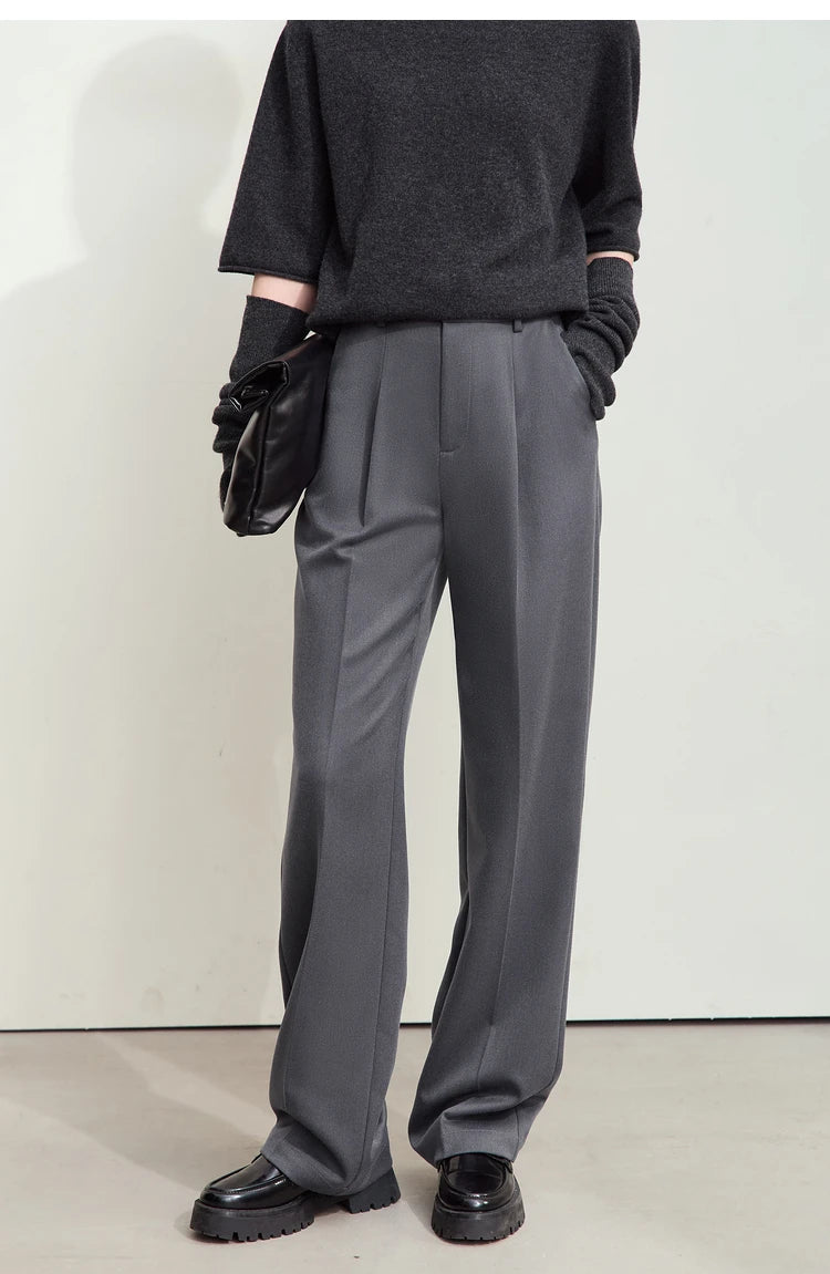 Model wearing tailored trousers in Dolphin color with hand in pocket — relaxed posture highlights ease of wear. From Borcelleclothes.