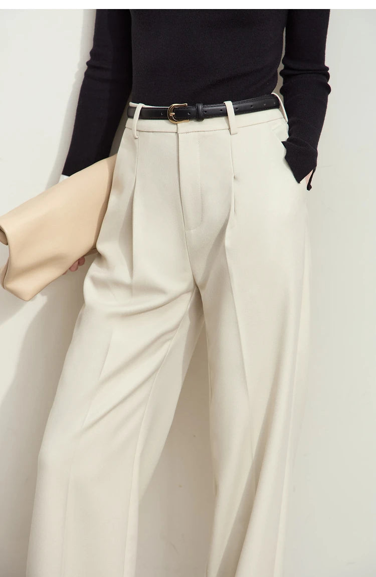 Model in Moon Mist trousers, front upper part — clean waistband and sharply pressed pleats. From Borcelleclothes.