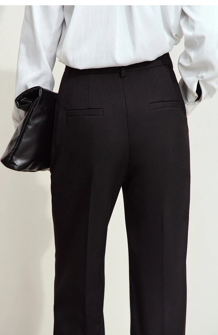 Upper back view of model in tailored trousers in Onyx — minimalist waistband with discreet pocket detailing. From Borcelleclothes.