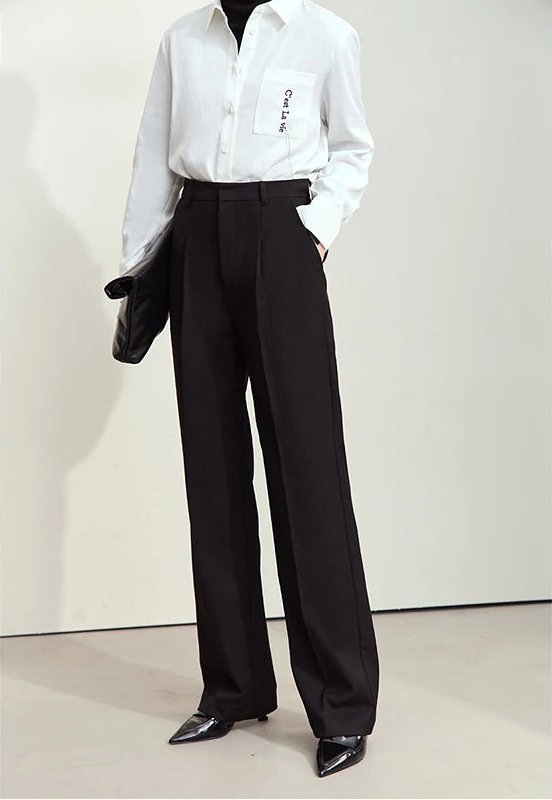 Model wearing tailored trousers in Onyx color with hand in pocket — relaxed posture highlights ease of wear. From Borcelleclothes.