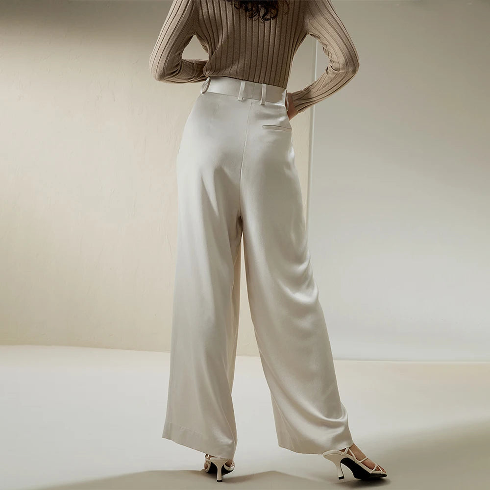 Back view of the Platinum silk trousers, showing clean tailoring and the gentle fall of wide-leg silk. From Borcelleclothes.