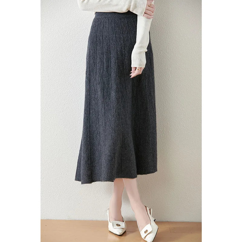 Textured merino wool skirt in Davy Grey, model with crossed legs, showing structure and quiet movement — From Borcelleclothes.
