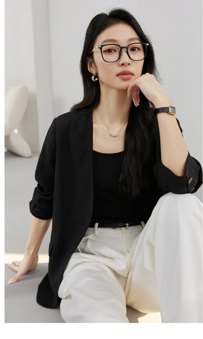 Model sitting on the floor in an Onyx textured pinstripe crinkle blazer. From Borcelleclothes.