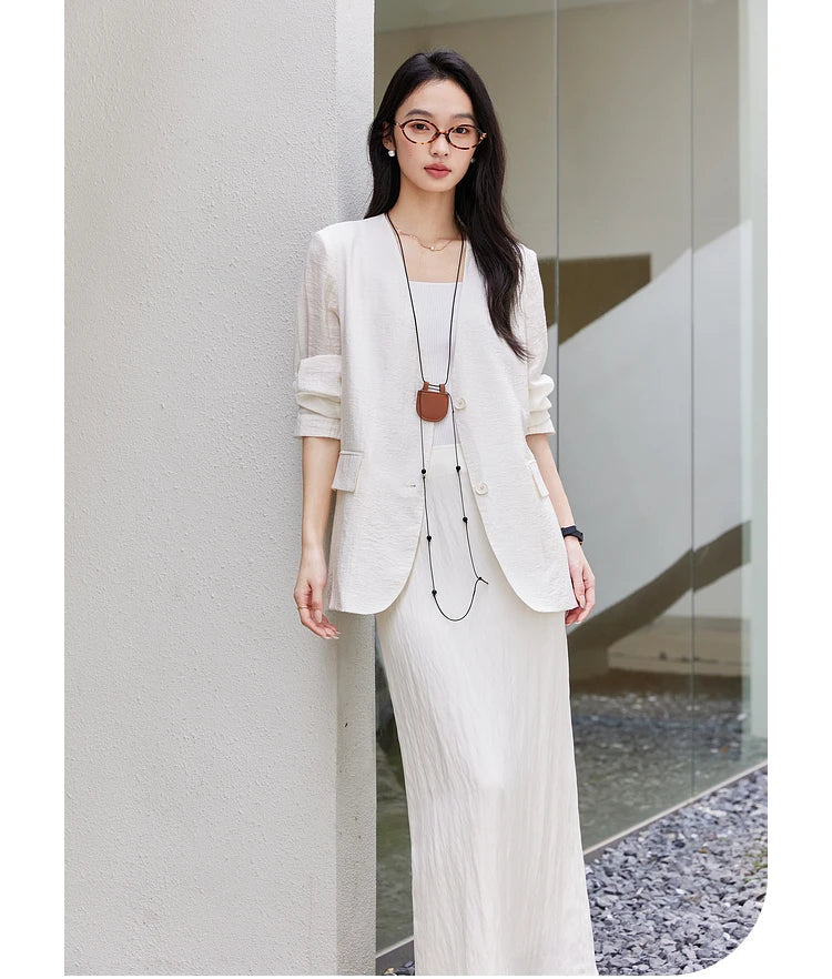 Model leaning against a wall in a Pearl Bush textured pinstripe crinkle blazer. From Borcelleclothes.