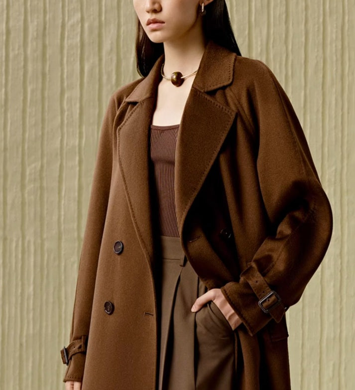 Model wearing the Women's Tibetan Cashmere Coat in Baker’s Chocolate, with one hand in a pants pocket, showcasing the coat's relaxed elegance. From Borcelleclothes.