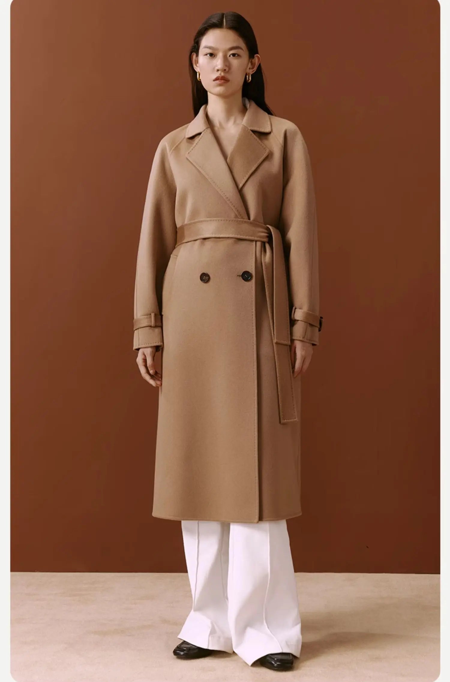 Model standing straight in the Women's Tibetan Cashmere Coat in French Beige, highlighting its timeless silhouette and refined details. From Borcelleclothes.