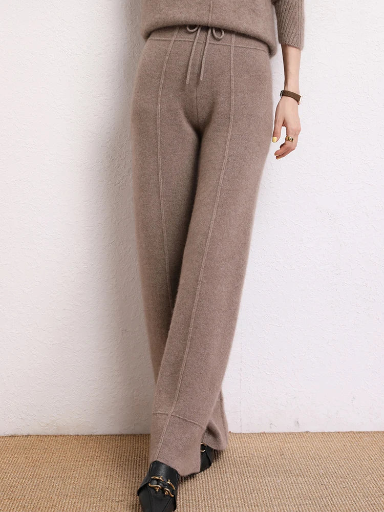 Model in Traced Seaming Cashmere Trousers in Almond Frost, with crossed legs — From Borcelleclothes.