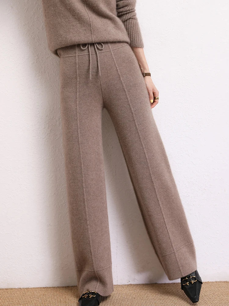 Traced Seaming Cashmere Trousers in Almond Frost, model with lifted leg — From Borcelleclothes.