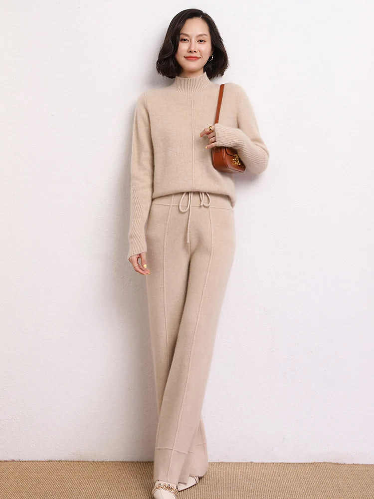Model wearing Traced Seaming Cashmere Trousers in Vanilla, bag over shoulder — From Borcelleclothes.